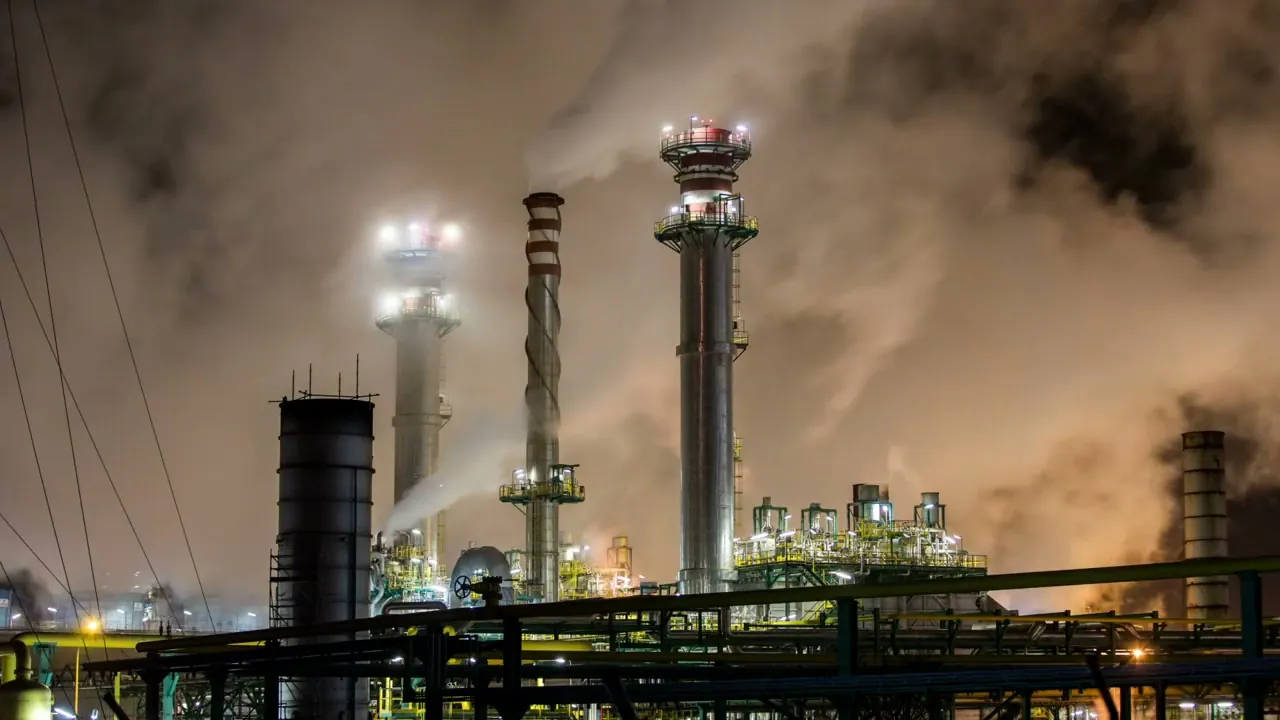 Refinery towers at night